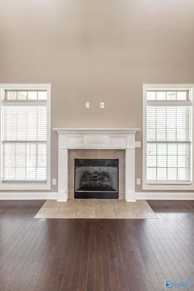 interior space with a tile fireplace, plenty of natural light, and light hardwood / wood-style flooring