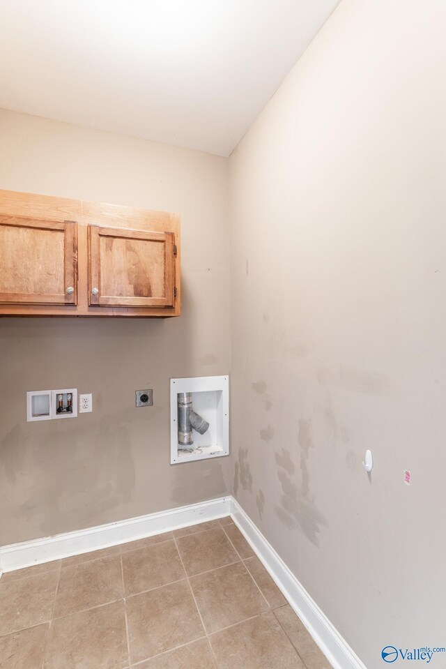 washroom featuring washer hookup, light tile patterned floors, electric dryer hookup, and cabinets