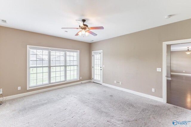 unfurnished room featuring light colored carpet and ceiling fan