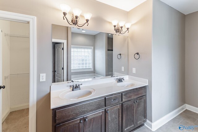 bathroom with an inviting chandelier, a bathing tub, tile patterned floors, and double sink vanity