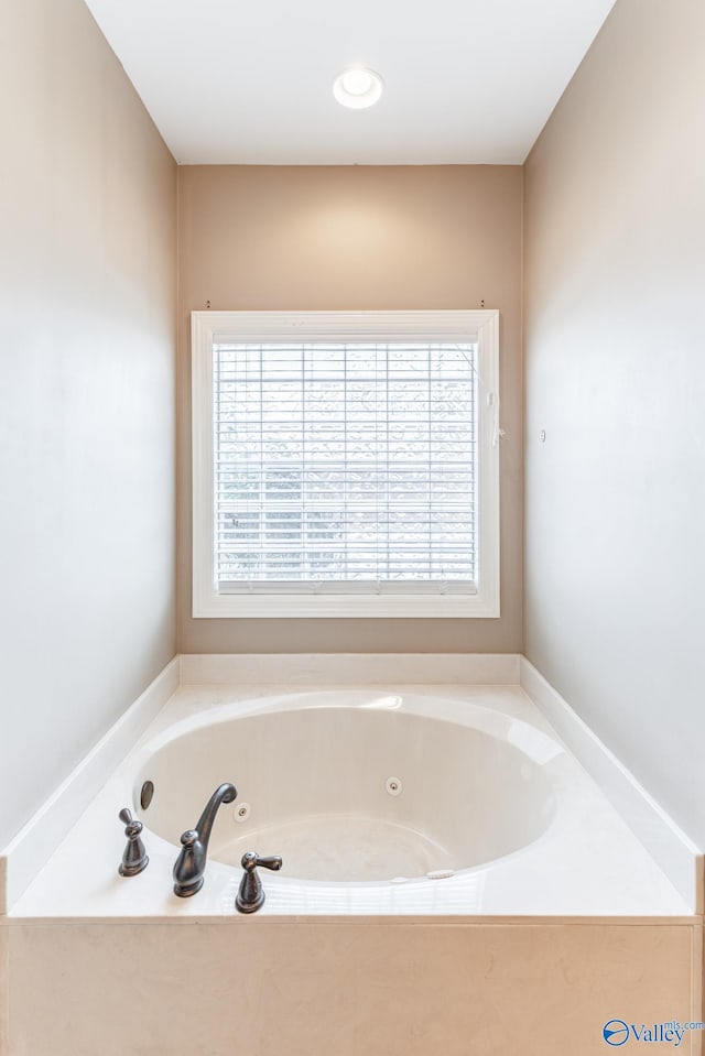 bathroom featuring a tub and plenty of natural light