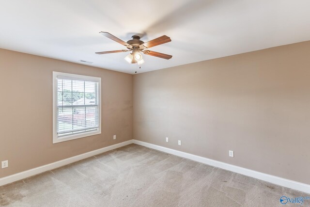 carpeted spare room featuring ceiling fan