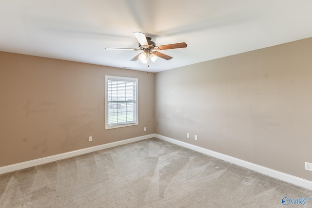 spare room with light colored carpet and ceiling fan