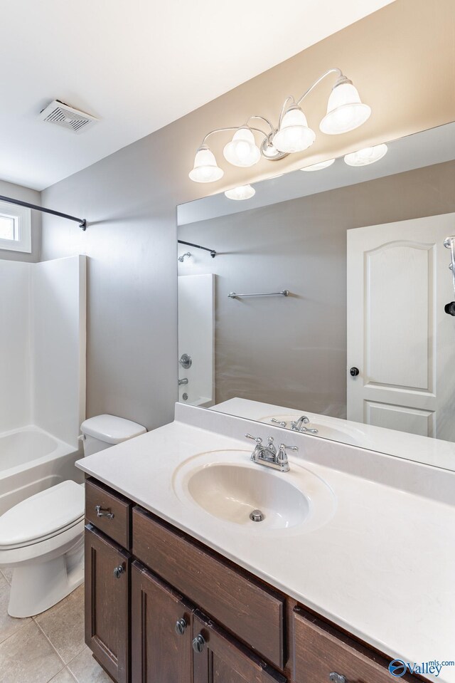 full bathroom with shower / bathtub combination, vanity, tile patterned floors, and toilet