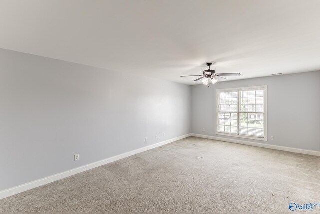 empty room featuring light carpet and ceiling fan