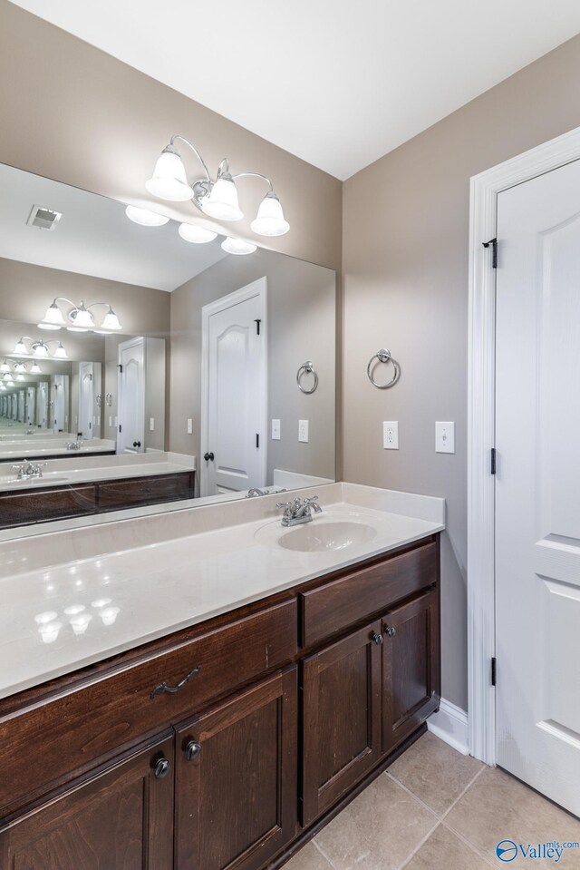 bathroom with tile patterned floors and vanity