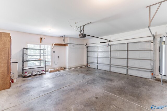 garage with electric water heater and a garage door opener