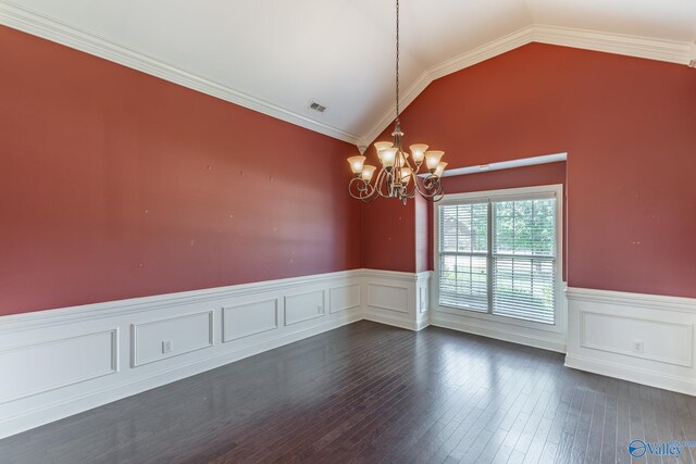 spare room featuring an inviting chandelier, crown molding, vaulted ceiling, and dark wood-type flooring