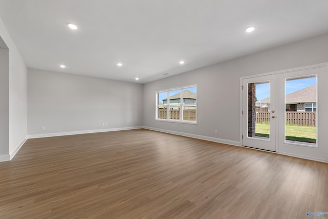 unfurnished bedroom featuring a walk in closet, light carpet, and a closet