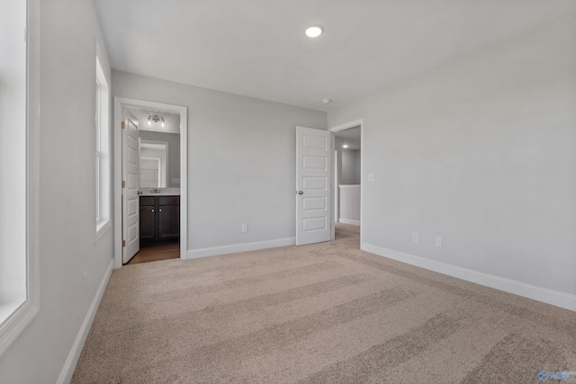 unfurnished room with light colored carpet and a raised ceiling