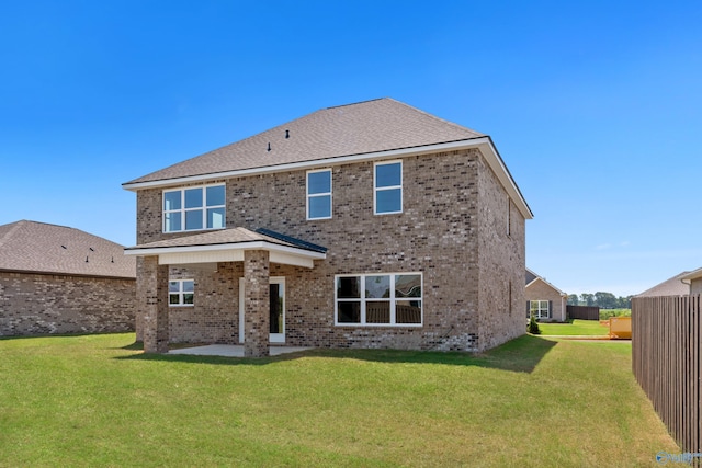 back of house with a yard, central air condition unit, and a patio area