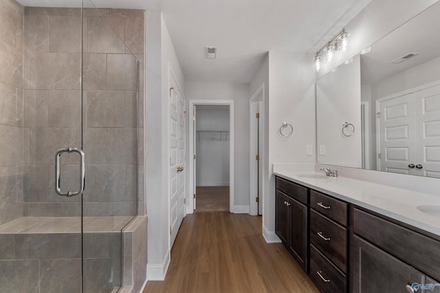 kitchen with gray cabinetry, backsplash, dark wood-type flooring, and stainless steel appliances