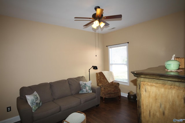 living room with ceiling fan and dark hardwood / wood-style flooring