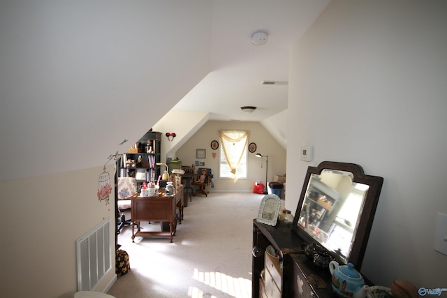 bonus room with light colored carpet and lofted ceiling