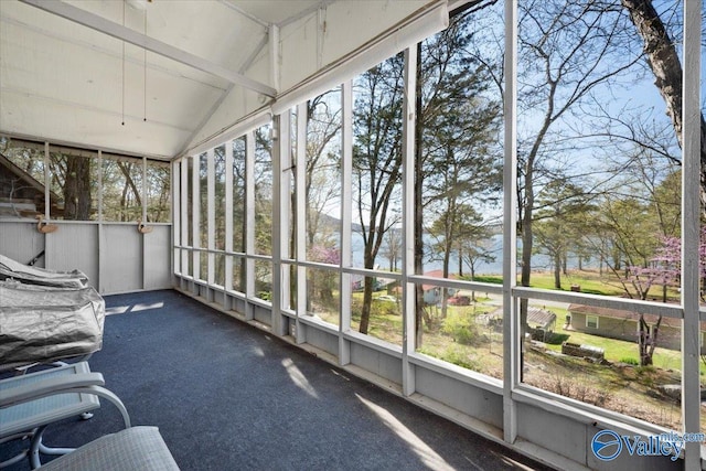 unfurnished sunroom with lofted ceiling