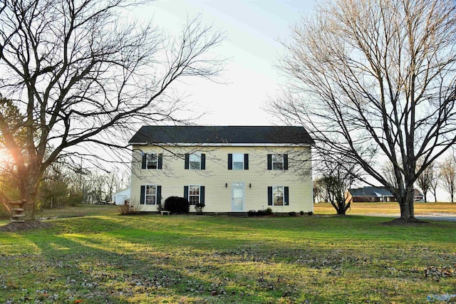 colonial-style house with a front lawn