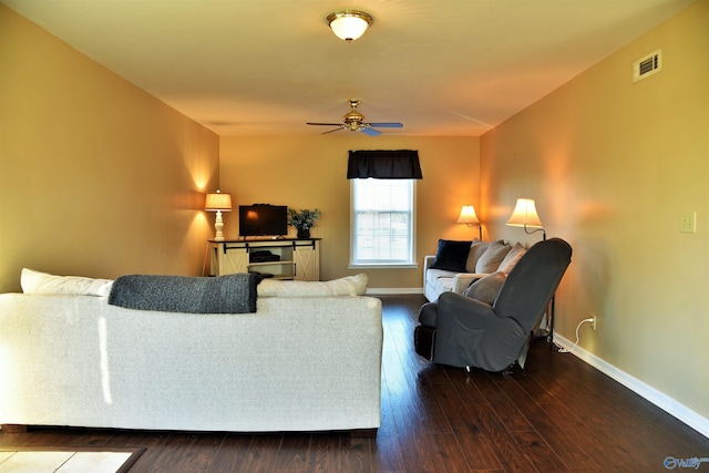 living room featuring ceiling fan and dark wood-type flooring