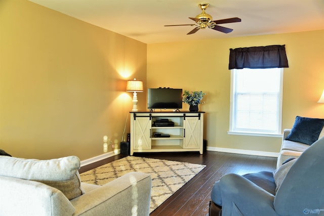 living room featuring ceiling fan and dark hardwood / wood-style flooring