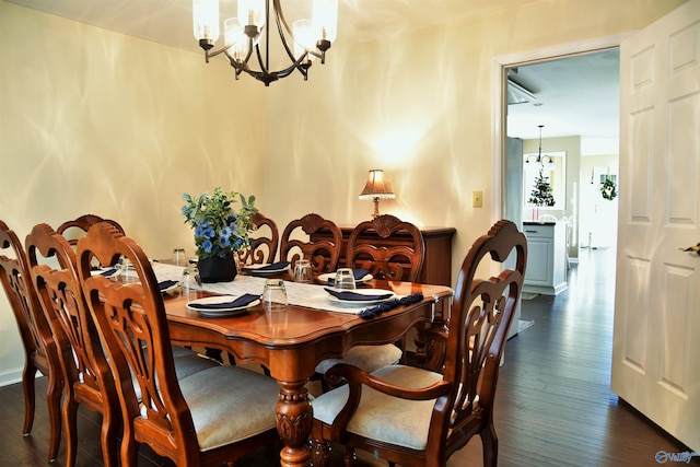 dining space with an inviting chandelier and dark wood-type flooring