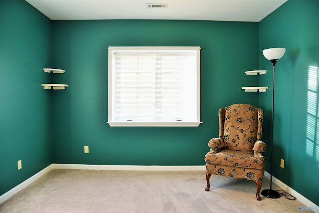 living area featuring plenty of natural light and carpet floors