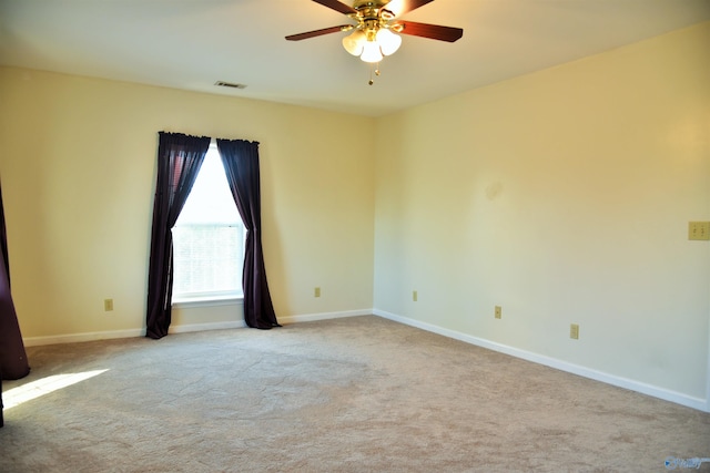 carpeted spare room featuring ceiling fan