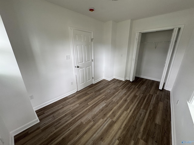 2217 Beasley Ave NW, Huntsville, AL 35816 - unfurnished bedroom featuring dark wood-style flooring, a closet, and baseboards