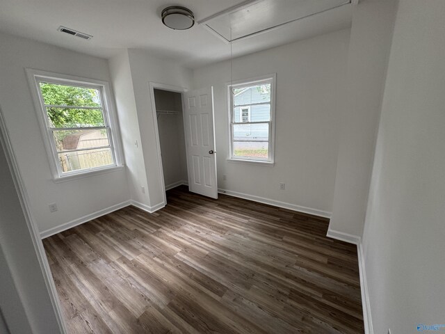 2217 Beasley Ave NW, Huntsville, AL 35816 - unfurnished bedroom featuring attic access, dark wood-style floors, baseboards, and a closet