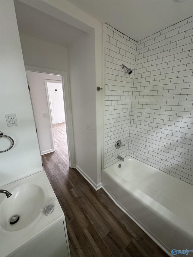 2217 Beasley Ave NW, Huntsville, AL 35816 - bathroom with wood finished floors, tub / shower combination, baseboards, and vanity