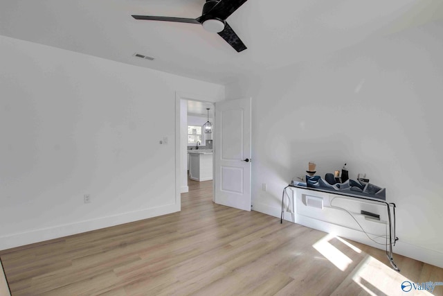 interior space with ceiling fan and light hardwood / wood-style flooring