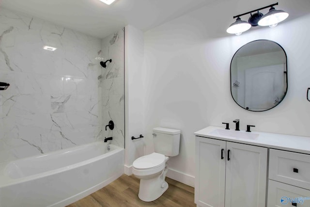 full bathroom with vanity, wood-type flooring, tiled shower / bath combo, and toilet