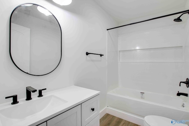 full bathroom featuring shower / tub combination, hardwood / wood-style floors, vanity, and toilet