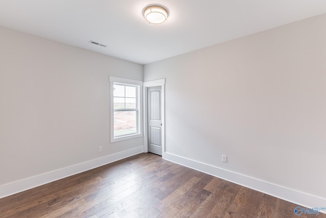 unfurnished room featuring dark hardwood / wood-style flooring