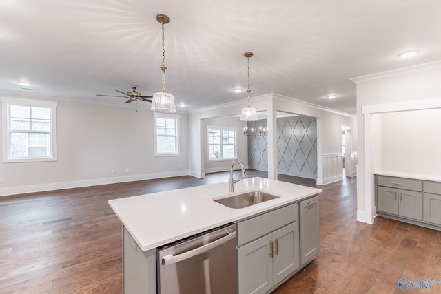 kitchen featuring sink, gray cabinets, a center island with sink, decorative light fixtures, and stainless steel dishwasher