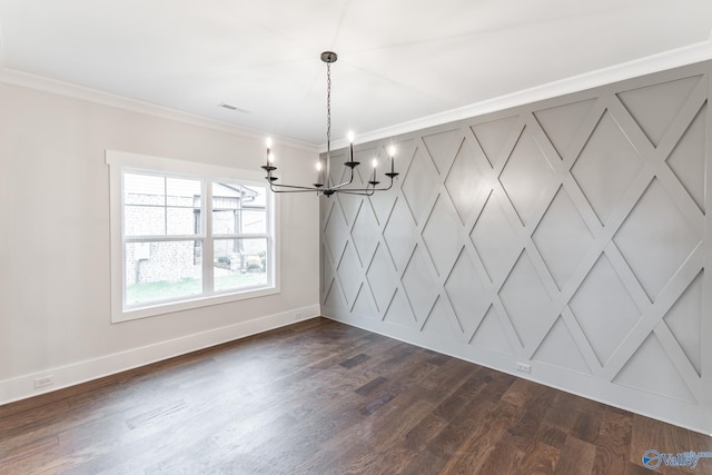 unfurnished dining area featuring dark hardwood / wood-style flooring, crown molding, and an inviting chandelier