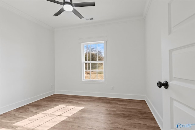 unfurnished room with wood finished floors, visible vents, crown molding, ceiling fan, and baseboards