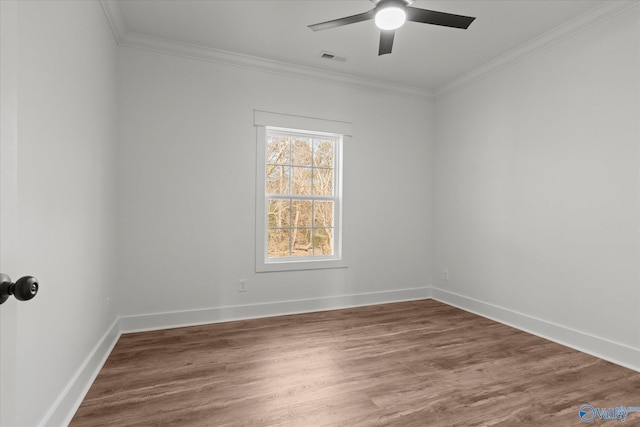 empty room with crown molding, ceiling fan, and wood finished floors