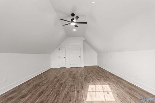 bonus room featuring ceiling fan, lofted ceiling, baseboards, and dark wood-type flooring