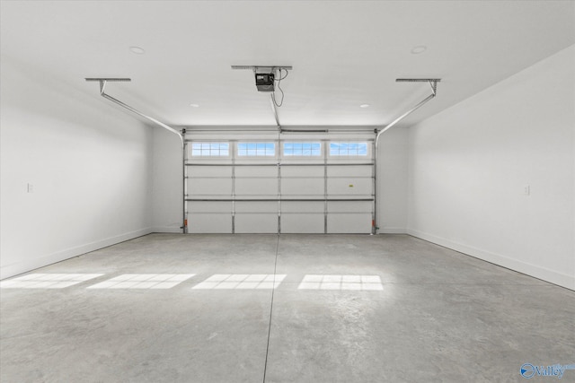 garage with baseboards and a garage door opener