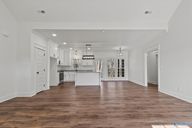 unfurnished living room with baseboards, recessed lighting, dark wood finished floors, and visible vents
