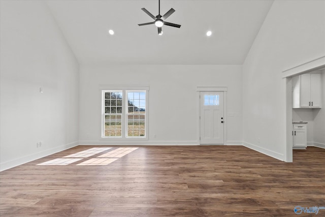 unfurnished living room featuring high vaulted ceiling, recessed lighting, dark wood finished floors, ceiling fan, and baseboards