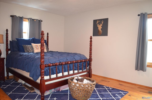 bedroom featuring hardwood / wood-style flooring and a textured ceiling