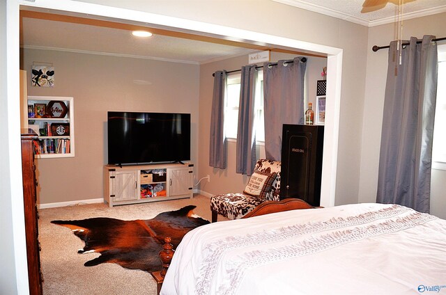 carpeted bedroom with ceiling fan and crown molding