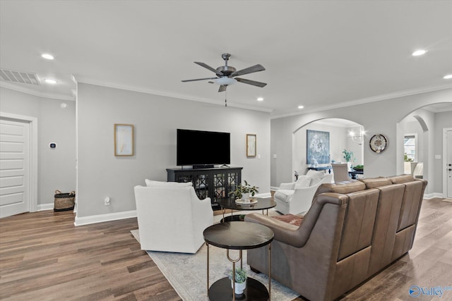 living room featuring hardwood / wood-style flooring, ceiling fan, and ornamental molding