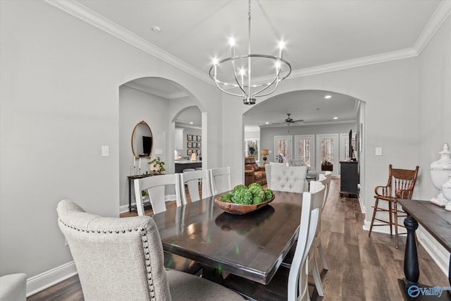 dining space with crown molding, dark hardwood / wood-style floors, and ceiling fan with notable chandelier