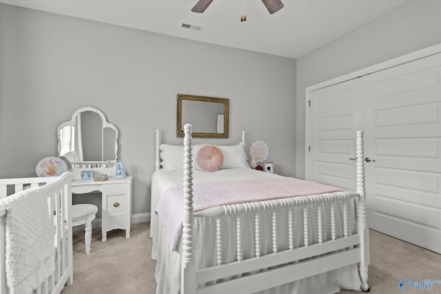 bedroom with light carpet and ceiling fan