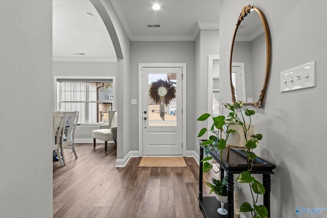 foyer entrance featuring wood-type flooring and ornamental molding