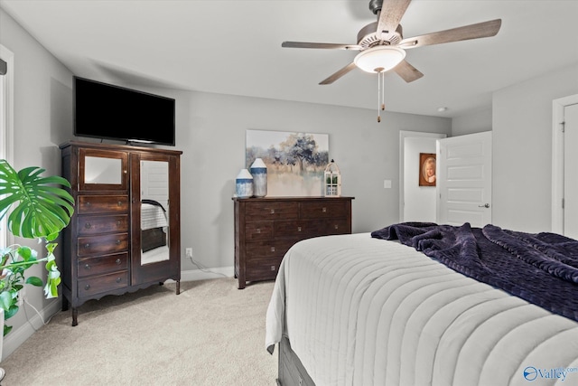 bedroom with ceiling fan and light carpet