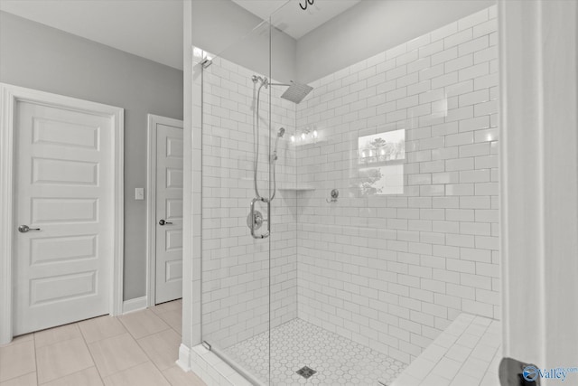 bathroom with tile patterned flooring and an enclosed shower