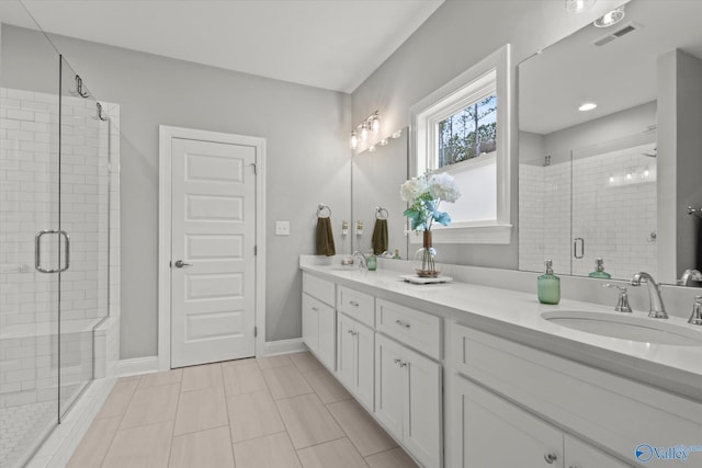 bathroom featuring tile patterned floors, vanity, and an enclosed shower