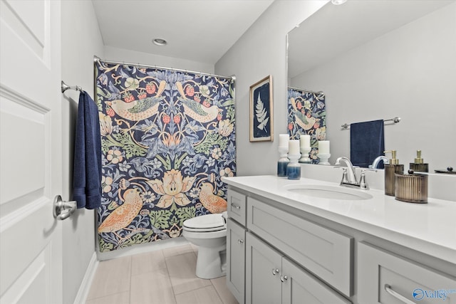 bathroom featuring tile patterned floors, vanity, and toilet